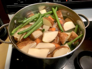 Pot of potatoes and green beans ready to boil.