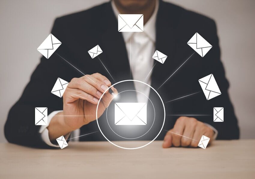 Businessman using a stylus to sort through email information.